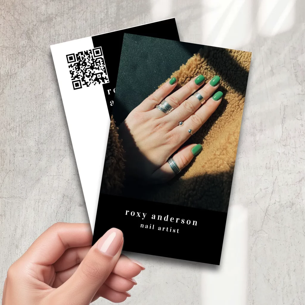 Nail artist business card with close-up photo of green nails and black background